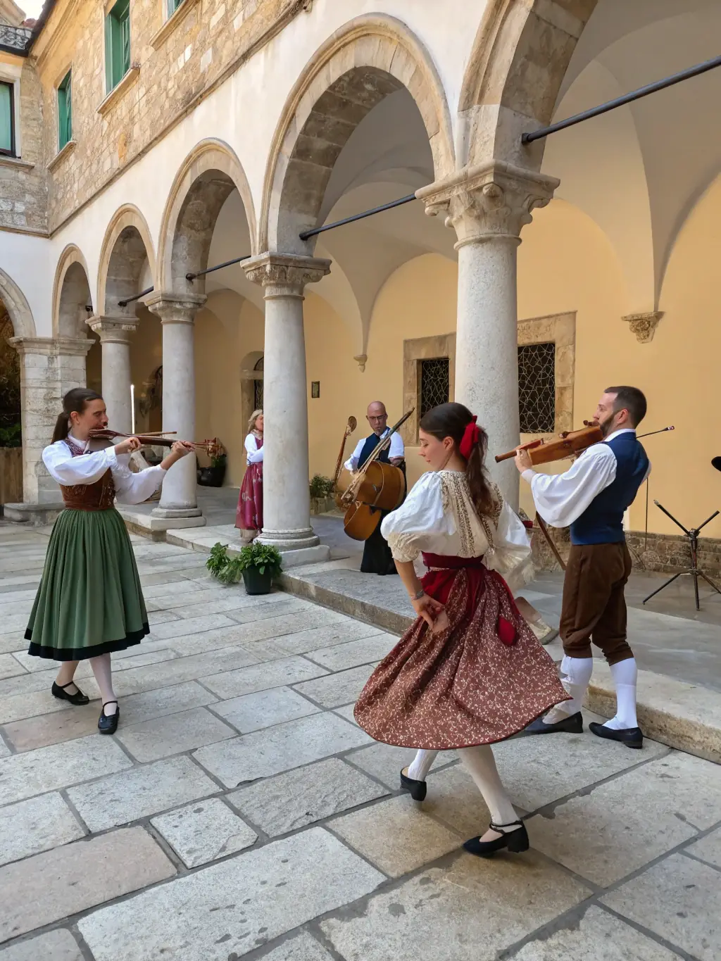 A vibrant image of a cultural event taking place in the Château's courtyard, featuring traditional music, dance, and local artisans showcasing their crafts.